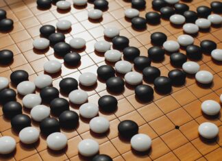 10년 전 알파고의 충격, 바둑의 모든 것을 바꾸다 a close up of a board game with black and white balls