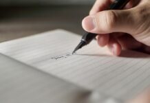 미국 학교에서 필기체 쓰기가 다시 주목받는 이유 a person writing on a piece of paper with a pen