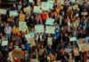 ICE 최대 구금시설 실태 폭로 Crowd of people holding signs at a protest