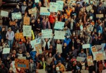 ICE 최대 구금시설 실태 폭로 Crowd of people holding signs at a protest
